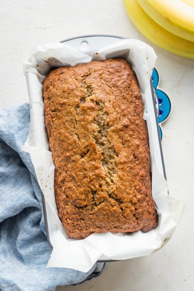 Overhead image of a loaf of banana bread just baked and still in the pan.