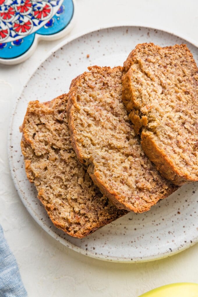 Small plate with three stacked slices of banana bread.
