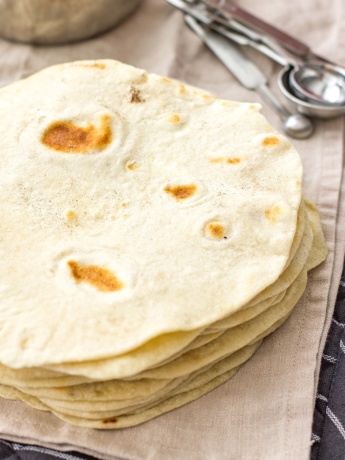 A stack of flour tortillas made from scratch.