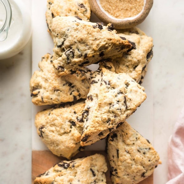 Small marble cutting board full of chocolate chip scones.