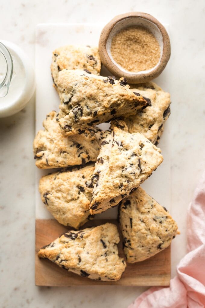Small marble cutting board full of chocolate chip scones.