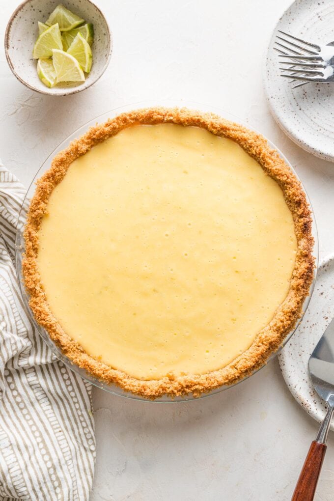 Overhead image of an ungarnished key lime pie, cooling just after coming out of the oven.