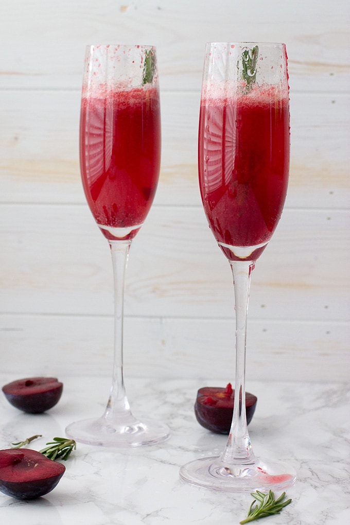 Rosemary plum bellini | A festive, fruit spin on the classic sparkling cocktail with champagne or prosecco. A perfect late summer or holiday drink!