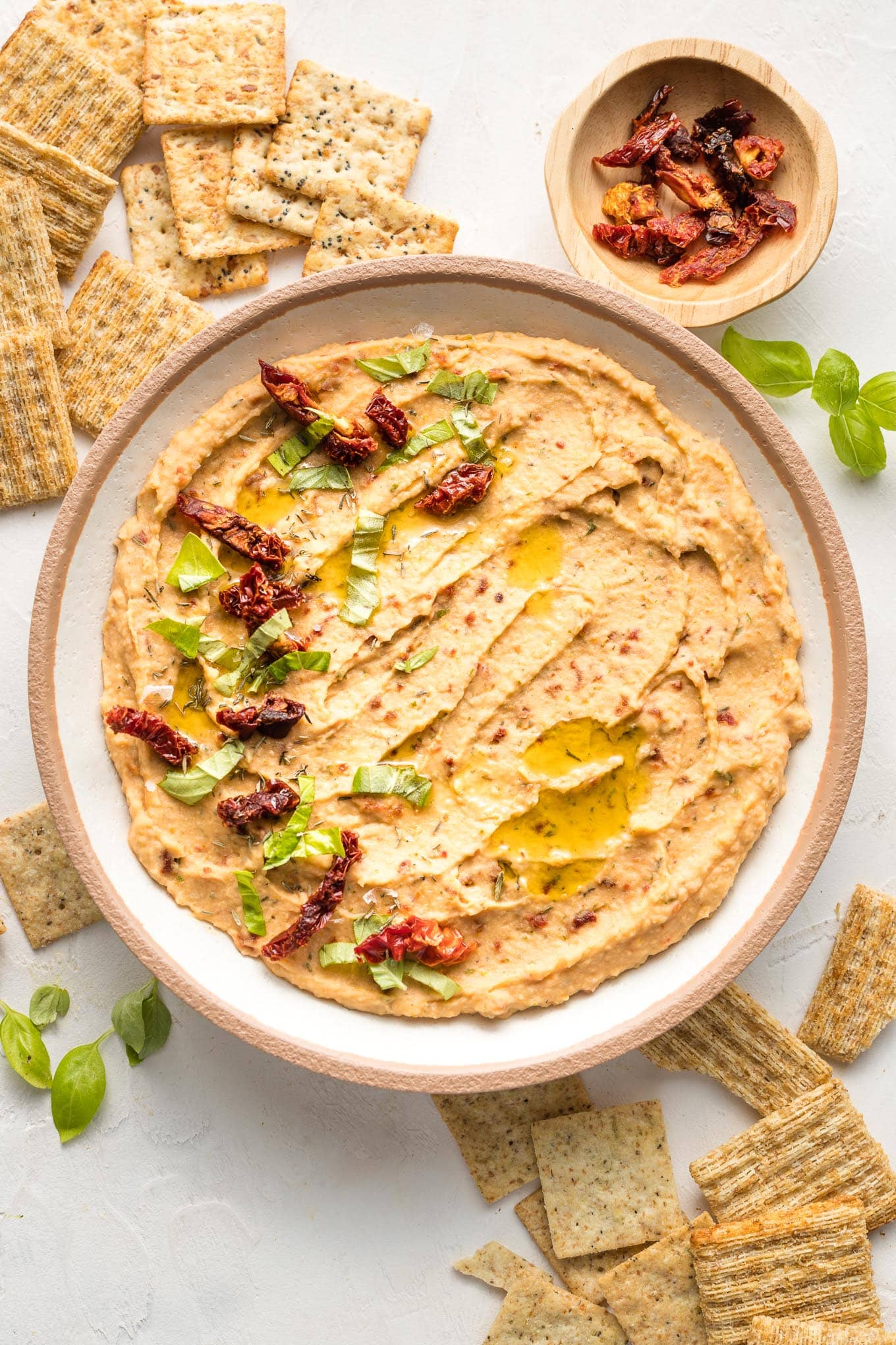 Bowl of sun-dried tomato dip, served with crackers.