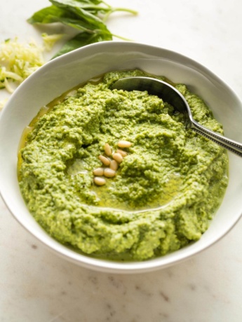 Small white bowl full of zucchini pesto.