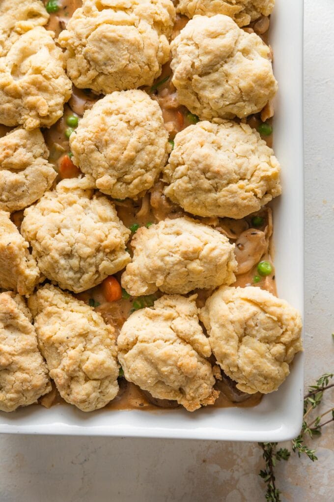 Biscuits placed on top of chicken pot pie filling and ready to bake.