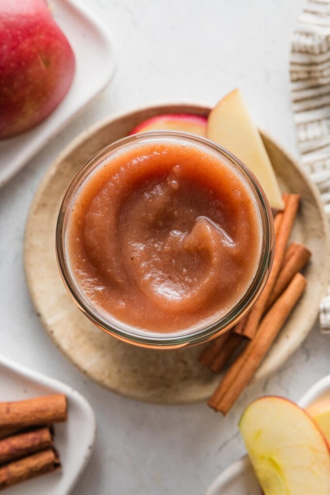 Countertop with a small plate and jar of homemade apple butter from the Instant Pot.
