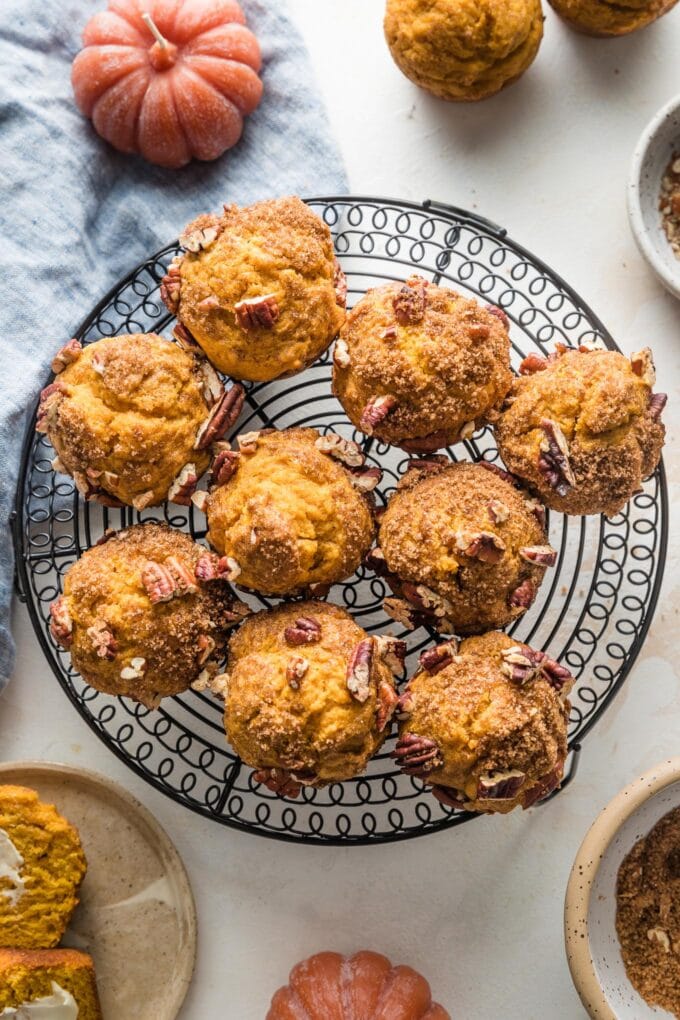 Wire cooling rack filled with pumpkin pecan muffins.