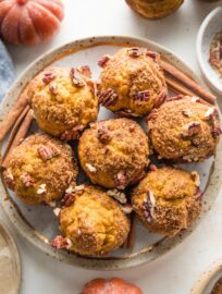 These pumpkin pecan crunch muffins are a delicious and classic fall treat! The tender, richly-spiced muffins pair perfectly with the crackly cinnamon sugar pecan topping. They're also quick and easy to whip up by hand, no fuss required.