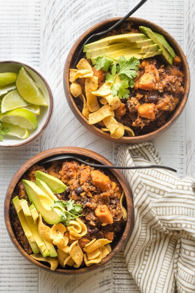 Two bowls of sweet potato black bean chili, with spoons to dig in.