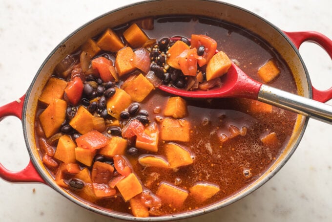 Broth, tomatoes, and black beans added to pot.