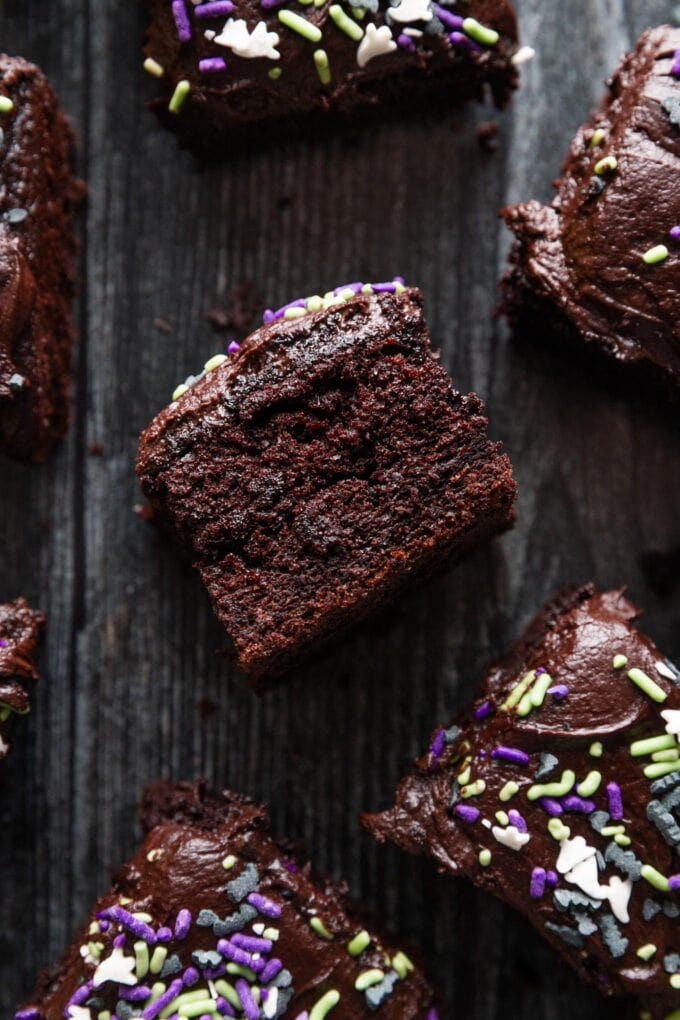 Side view of a square of blackout chocolate buttermilk cake to show the super moist, tender crumb.