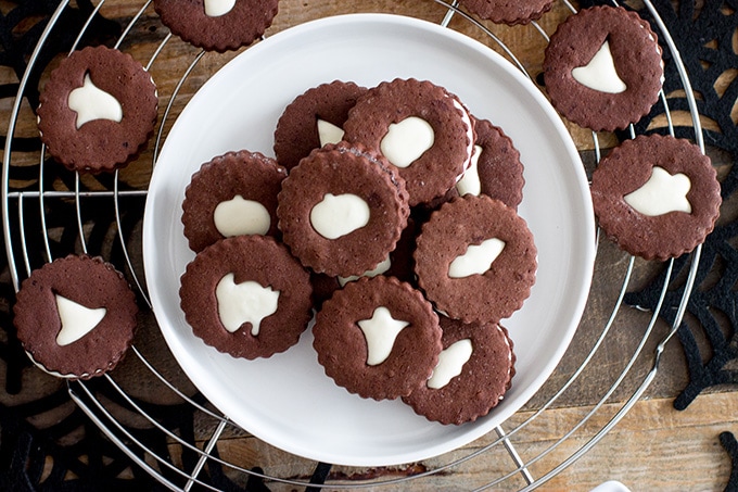Spooky chocolate Linzer cookies | Dark chocolate sugar cookies sandwiched with an easy marshmallow cream frosting, with spooky cut-outs for a Halloween treat! #halloween #chocolatesugarcookies