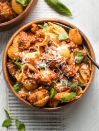 Bowl of pasta served with bolognese sauce.