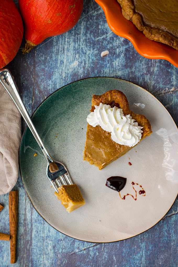 A slice of bourbon molasses-spiked pumpkin pie with whipped cream.