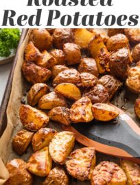 These Parmesan Crusted Red Potatoes are tossed with fragrant herbs and oven-roasted for a simple, versatile, and irresistible side dish. High heat gives these humble potatoes a deliciously crispy texture that will have you sneaking bites straight off the pan!