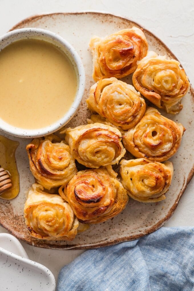 Small plate filled with turkey roll ups baked with Swiss cheese and a honey mustard glaze in between layers of crescent roll dough.