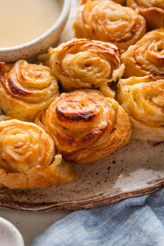 Close up of turkey party rolls served with honey mustard dipping sauce.