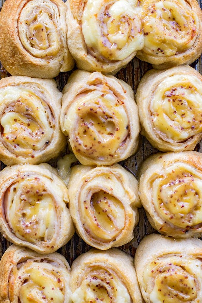 A close-up of turkey gouda party rolls with honey mustard glaze.