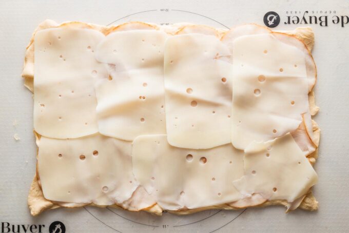Crescent roll dough pressed into a sheet and topped with thinly-sliced turkey and Swiss cheese.