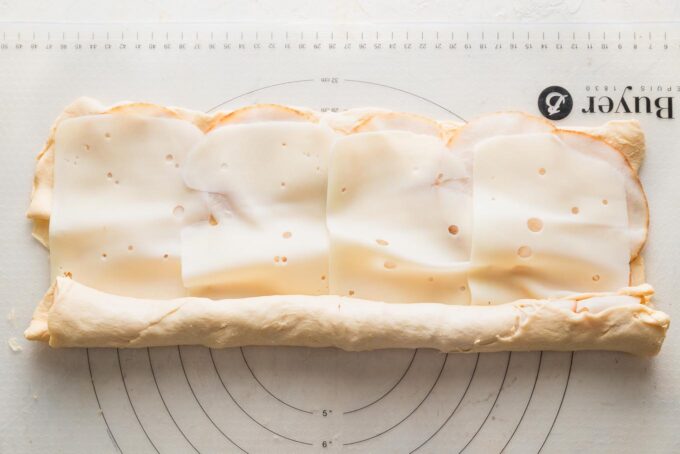 Partially rolled up crescent dough sheet.