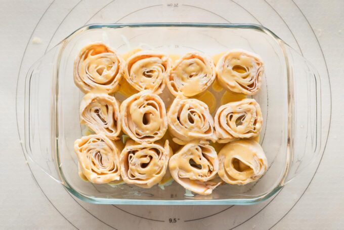 Turkey party rolls brushed with honey mustard glaze and ready to bake.