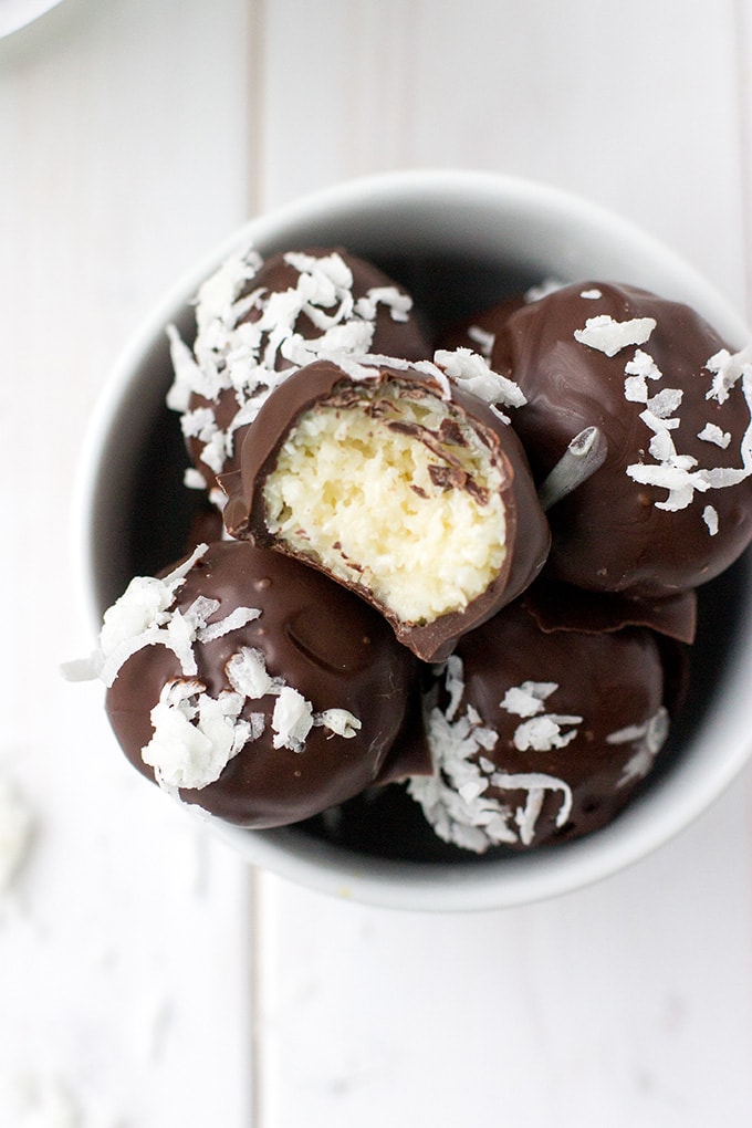 A close-up image of dark chocolate coconut truffles.