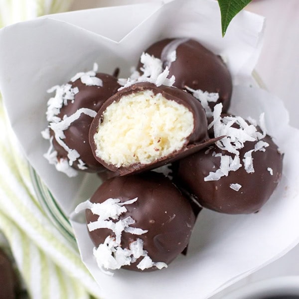 A close-up image of dark chocolate coconut truffles.