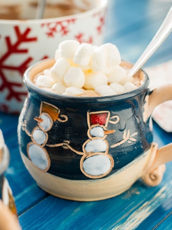 A mug full of classic hot cocoa topped with mini marshmallows.