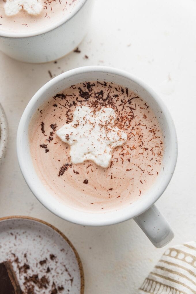 Homemade hot cocoa topped with marshmallows and chocolate shavings.