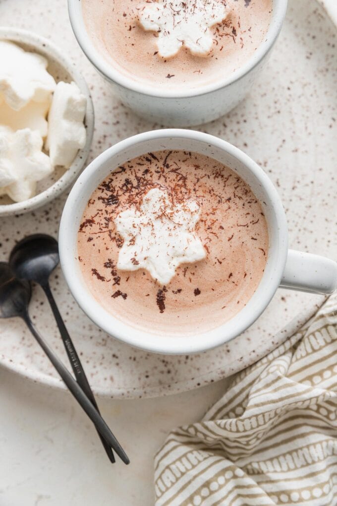 Overhead view of a mug filled with homemade hot cocoa and a snowflake-shaped marshmallow.