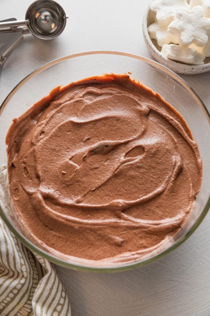 Homemade hot cocoa mix in a Pyrex container, ready to store in the refrigerator.