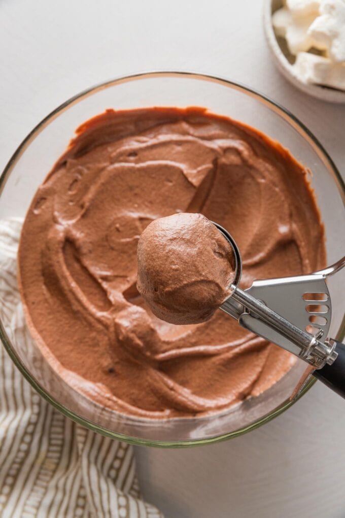 Large cookie scoop full of homemade hot cocoa mix.