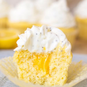 Perfect filled lemon cupcakes, with lemon curd in the center and topped with cream cheese poppyseed frosting. #springdesserts #lemondesserts #cupcakes #lemon
