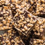 Close up of a plate filled with chocolate shortbread toffee cookie bars.