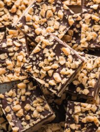 Close up of a plate filled with chocolate shortbread toffee cookie bars.