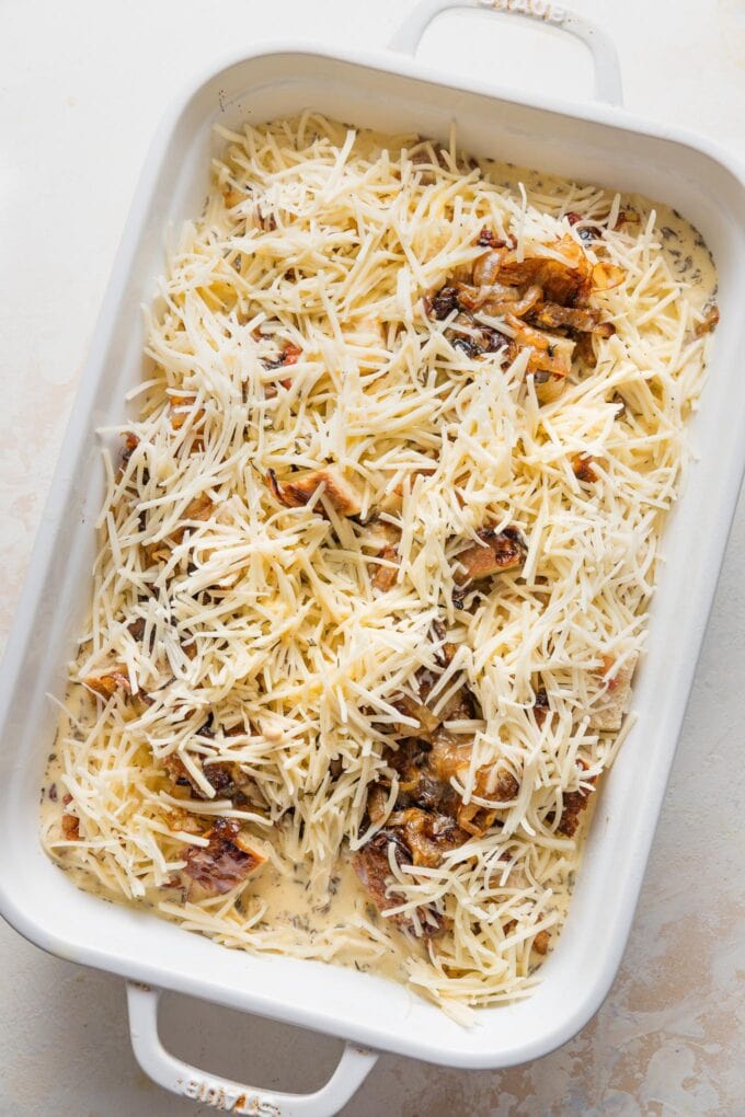 Cheese and egg mixture poured over to create an unbaked strata ready for refrigeration.