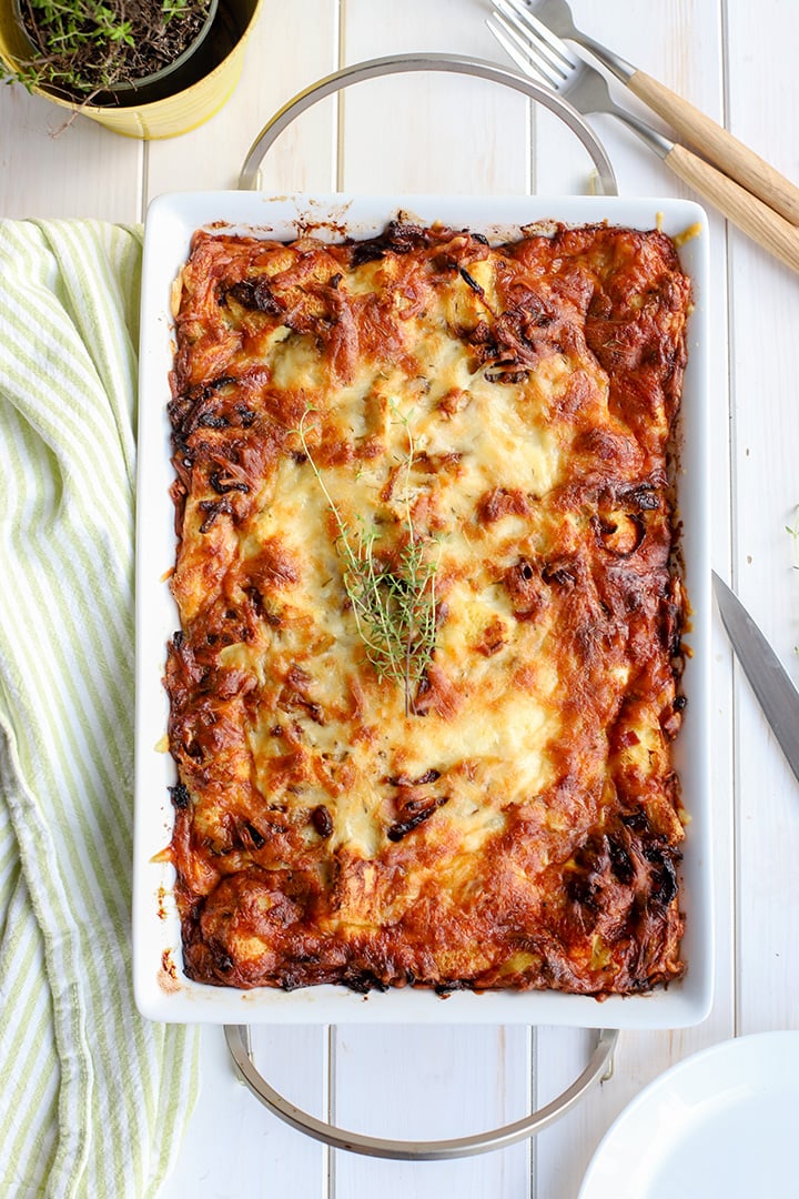 A large pan of breakfast strata with pancetta and caramelized onions.