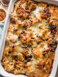 Large breakfast strata with pancetta, caramelized onions, and Gruyere cheese in a deep 9x13-inch baking pan.