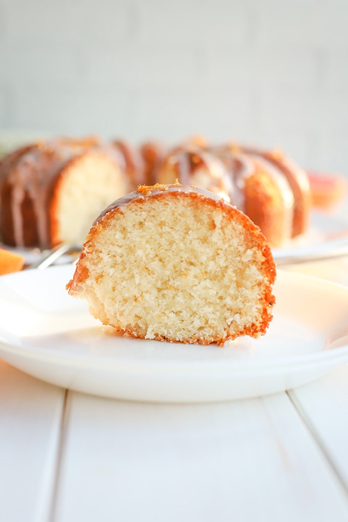 A cut slice of glazed grapefruit bundt cake.