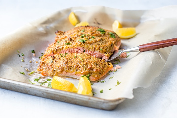 Serving a portion of mustard-crusted panko salmon.