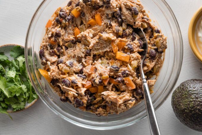 Filling for chicken black bean taquitos mixed together in a prep bowl.