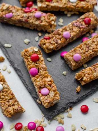 A slate tray filled with M&M pretzel granola bars.