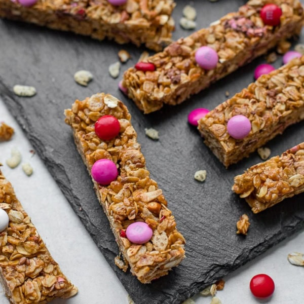 A slate tray filled with M&M pretzel granola bars.