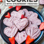 SO fun for Valentine's Day! The best cut-out chocolate sugar cookies swept with an easy, delicious strawberry frosting! #sugarcookies #chocolatecookies #strawberry #valentinesday