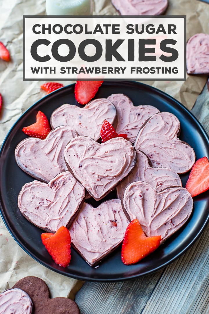 SO fun for Valentine's Day! The best cut-out chocolate sugar cookies swept with an easy, delicious strawberry frosting! #sugarcookies #chocolatecookies #strawberry #valentinesday