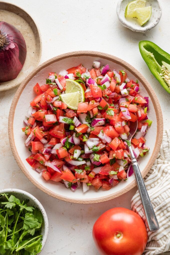 Countertop set with the fixings for homemade tomato salsa, pico de gallo style.