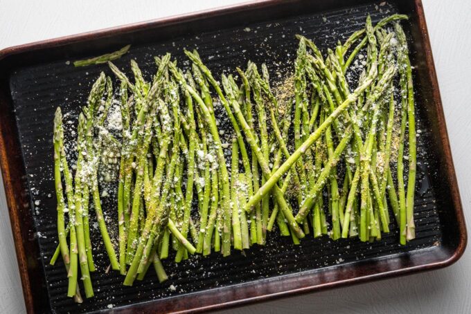 Sheet pan filled with asparagus ready to roast.