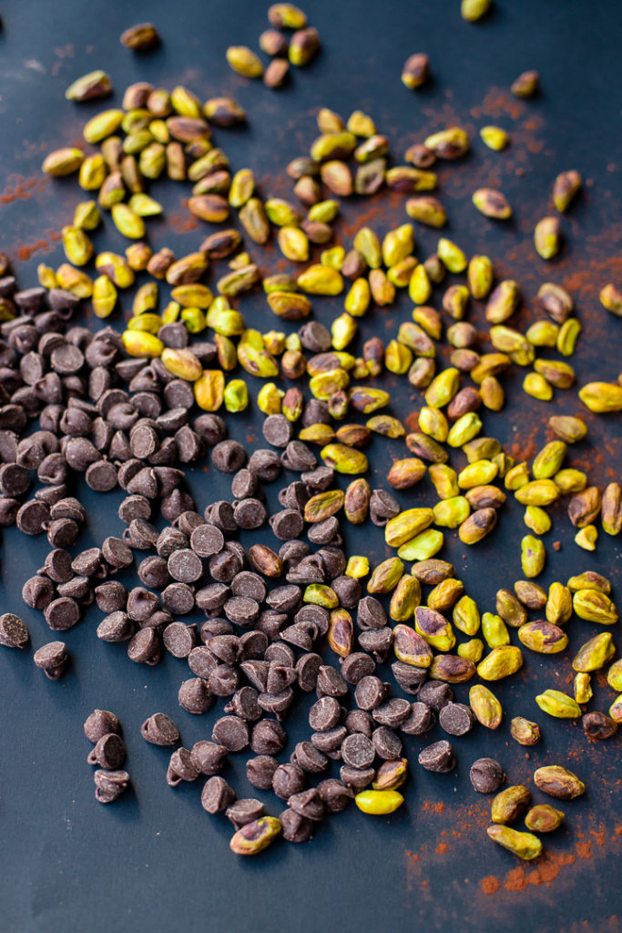 Scattered chocolate chips and pistachio pieces.