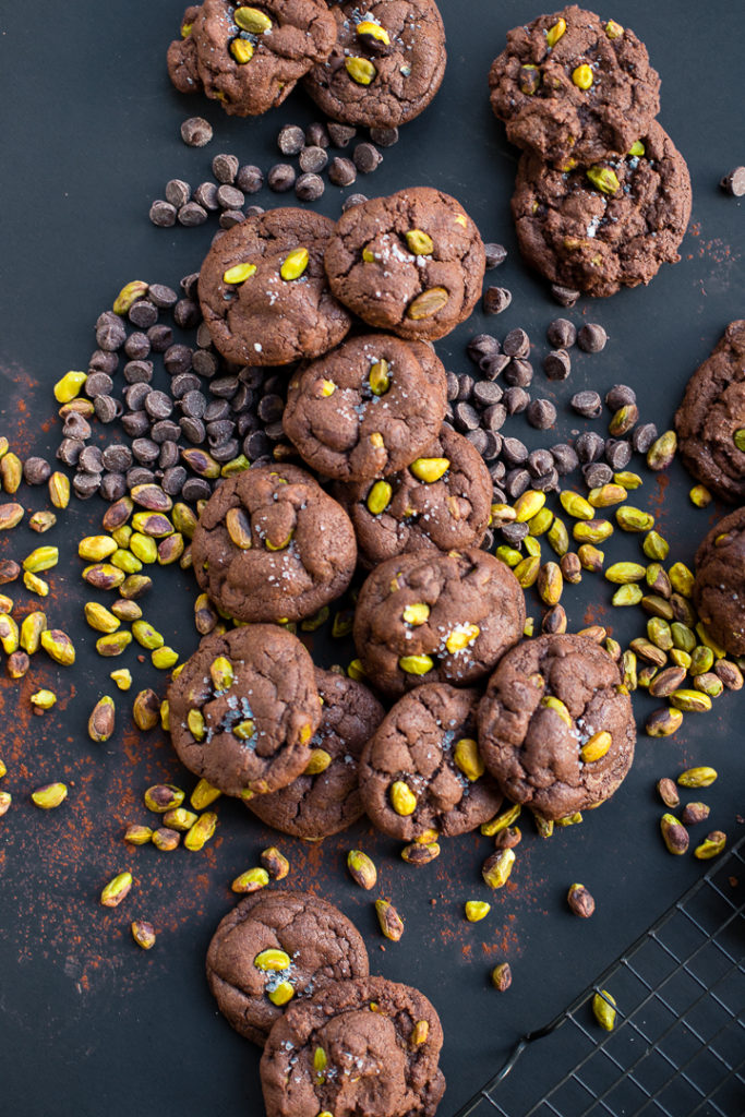 Flat-lay photo of sea salt pistachio chocolate chip cookies.